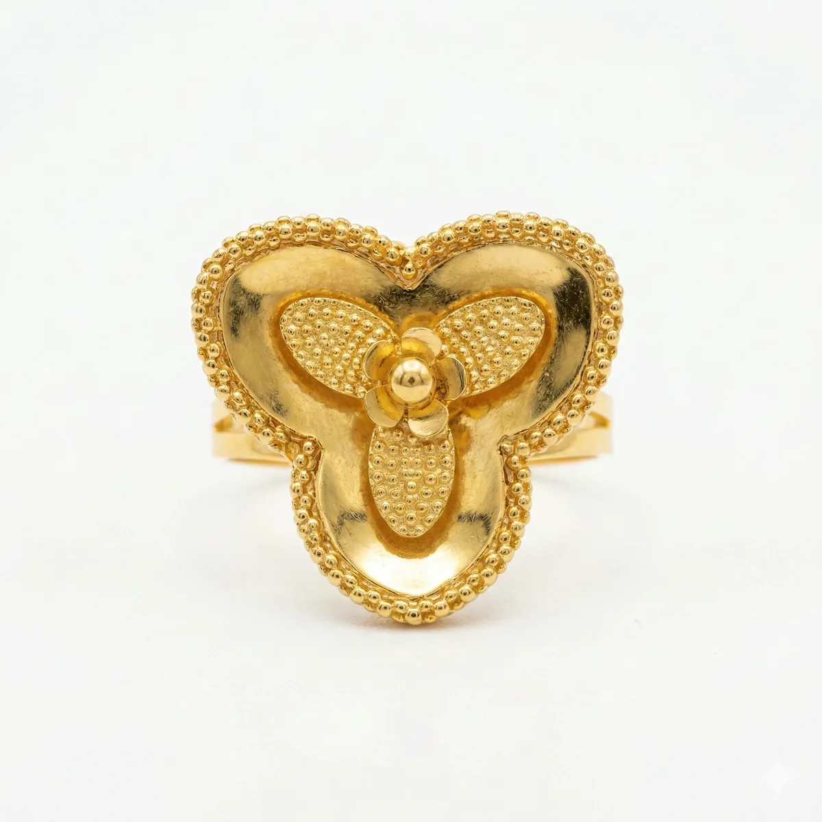 21K gold flower design ring with textured details on a model hand and white background