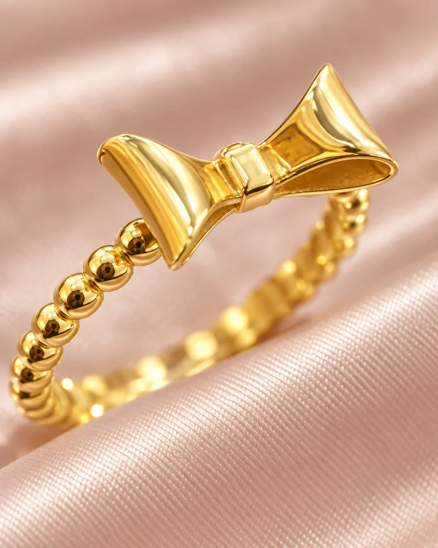 Macro of the polished gold bow and beaded band