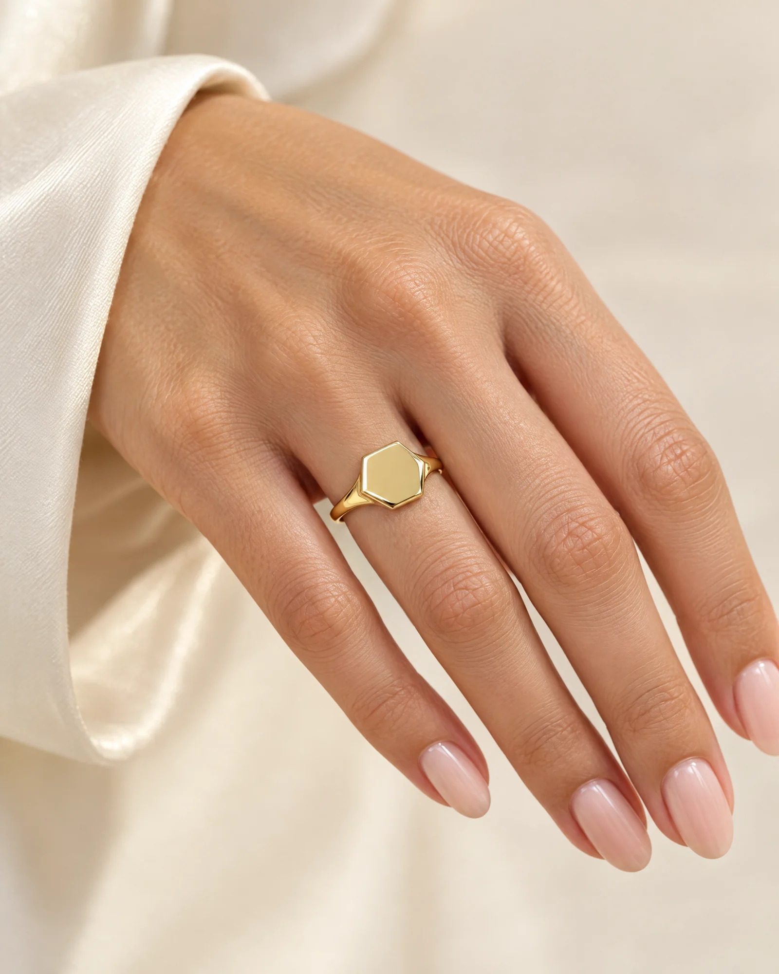 18K gold hexagon signet ring worn on the ring finger