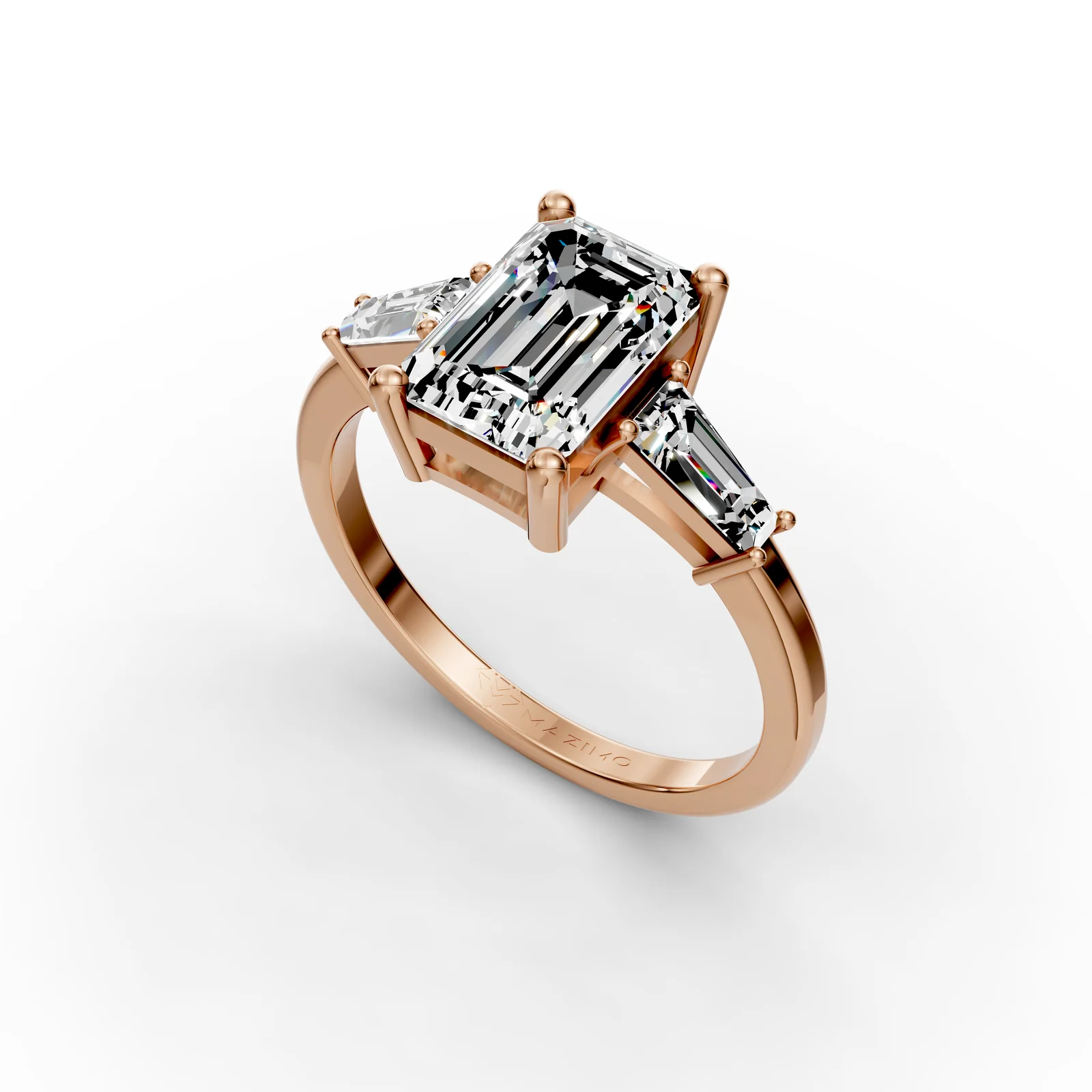 Emerald and Baguette Three Stone Ring in 18K Rose Gold, 2 ct emerald-cut diamond with two tapered baguettes, angled view