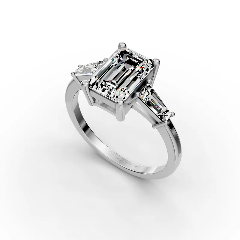 Emerald and Baguette Three Stone Ring in 18K White Gold, 2 ct emerald-cut diamond with two tapered baguettes, angled view