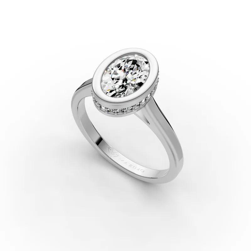 Oval Bezel Solitaire Ring in 18K White Gold, 1.5 ct oval diamond in a bezel with a ring of small diamonds below, angled view