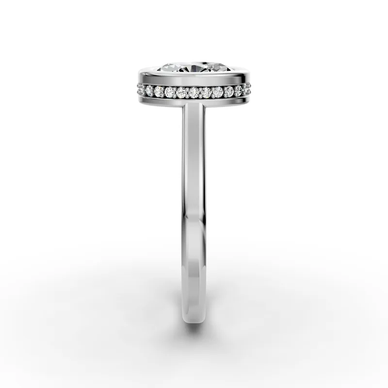 Oval Bezel Solitaire Ring in 18K White Gold, 1.5 ct oval diamond in a bezel with a ring of small diamonds below, side profile