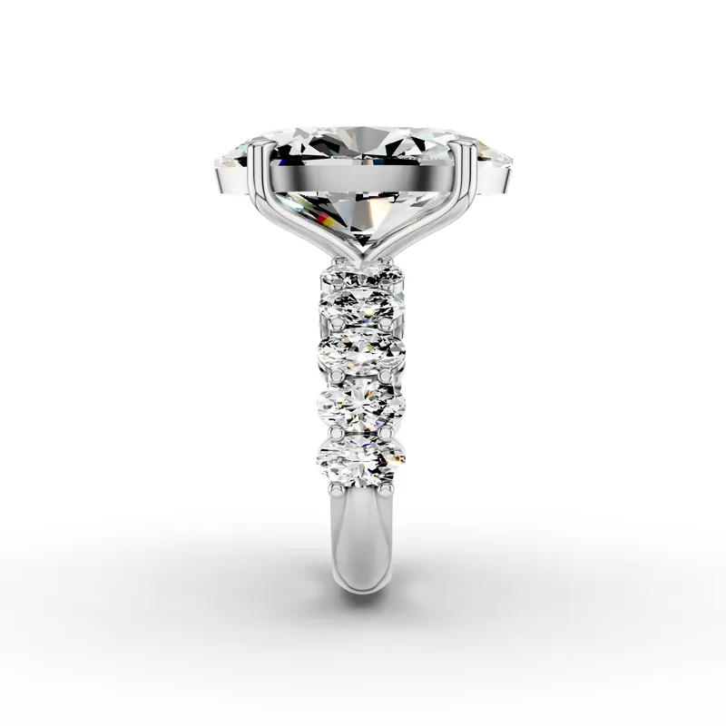 Oval Side Stone Ring, 10 ct in 18K White Gold, 10 ct oval diamond in four claws with oval diamonds along the band, side profile