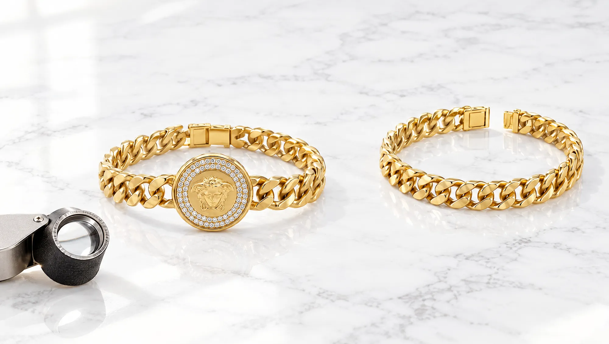 An 18K Italian gold Cuban link bracelet and a Medusa bracelet with a diamond halo on white marble