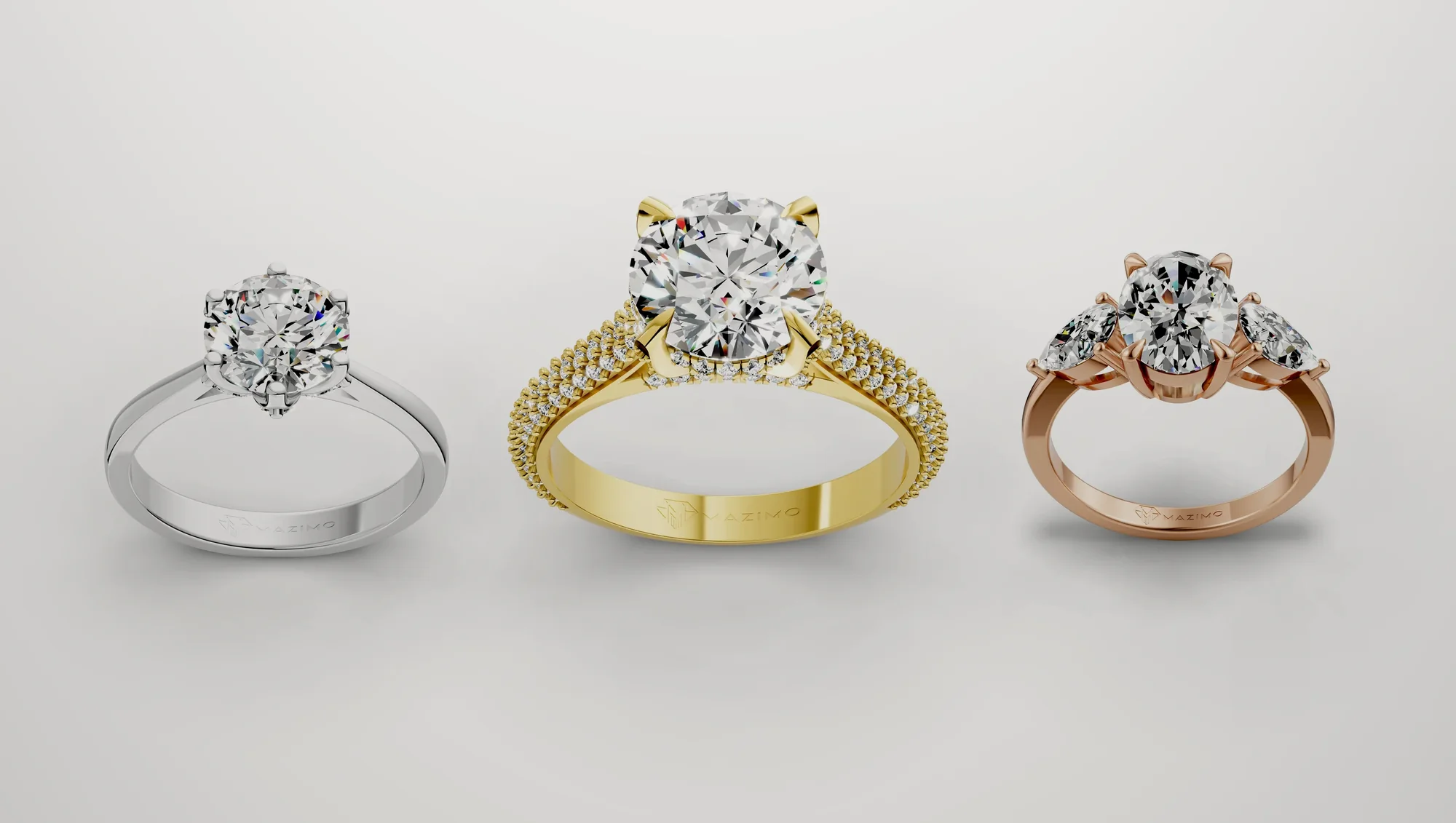 Three Mazimo diamond rings in white, yellow and rose gold: Round Six Claw Solitaire Ring, Round Pavé Solitaire Ring and Oval and Pear Three Stone Ring
