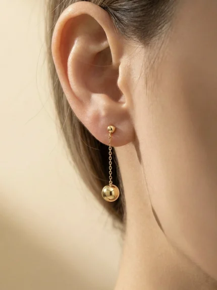 18K gold Spanish collection sphere drop earrings with delicate chain and polished gold ball, 0.72 grams