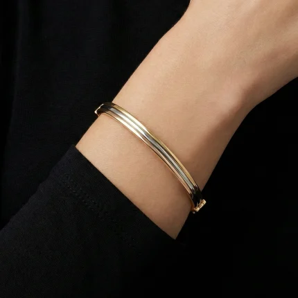 18K gold Mazimo collection tri-tone slim bangle with yellow, white, and rose gold bands, 7.40 grams