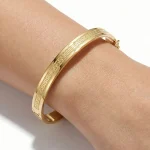 18K gold Mazimo Greek key engraved bangle bracelet with polished finish, 8.10 grams
