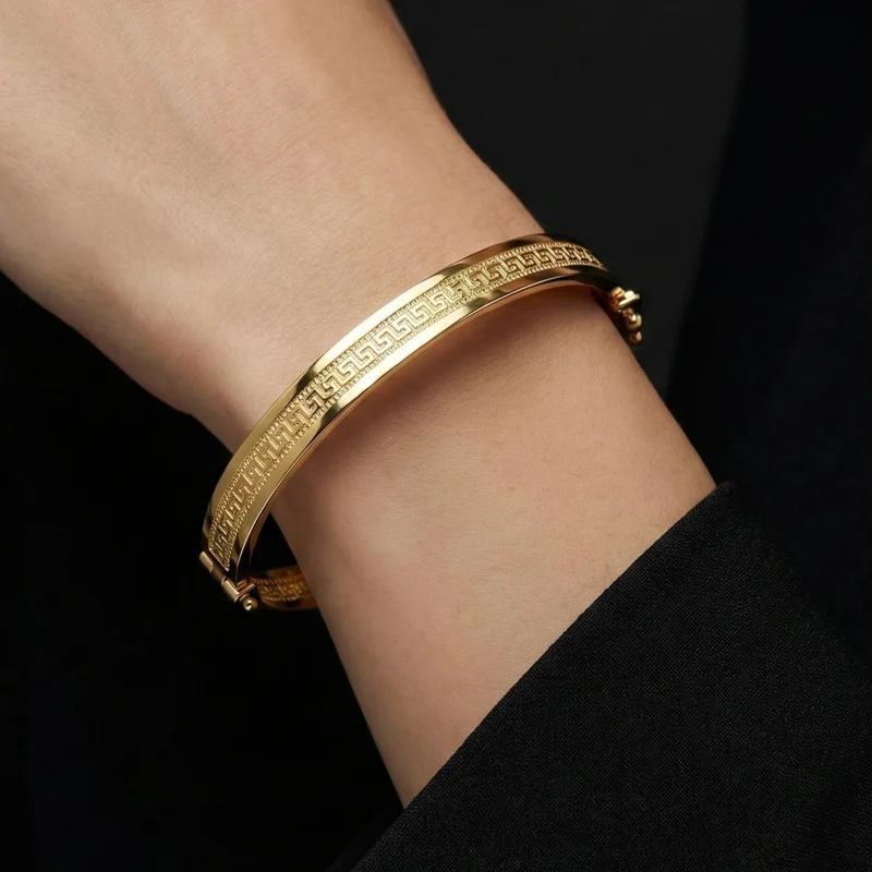 18K gold Mazimo Greek key engraved bangle bracelet with polished finish, 8.10 grams