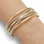18K gold Mazimo collection diamond wave bangle with pavé-set diamonds and polished gold curves, 10.80 grams