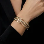 18K gold Mazimo collection diamond wave bangle with pavé-set diamonds and polished gold curves, 10.80 grams