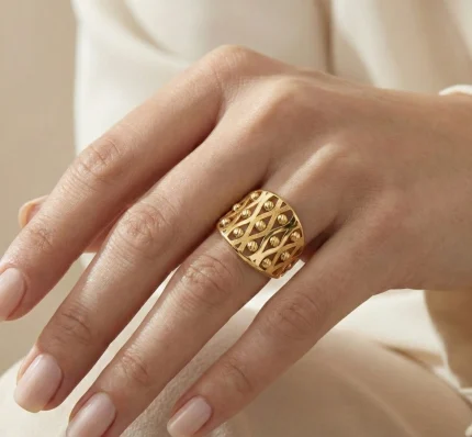 21K yellow gold wide lattice ring with diamond-cut textured details on white background